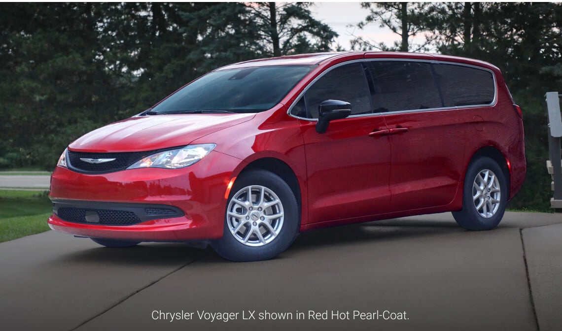 Front three-quarter view of a 2026 Chrysler Voyager LX in Red Hot Pearl-Coat parked on a paved driveway.