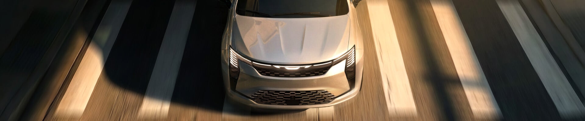 Overhead view of 2027 Chrysler Pacifica driving over a crosswalk on a city street.